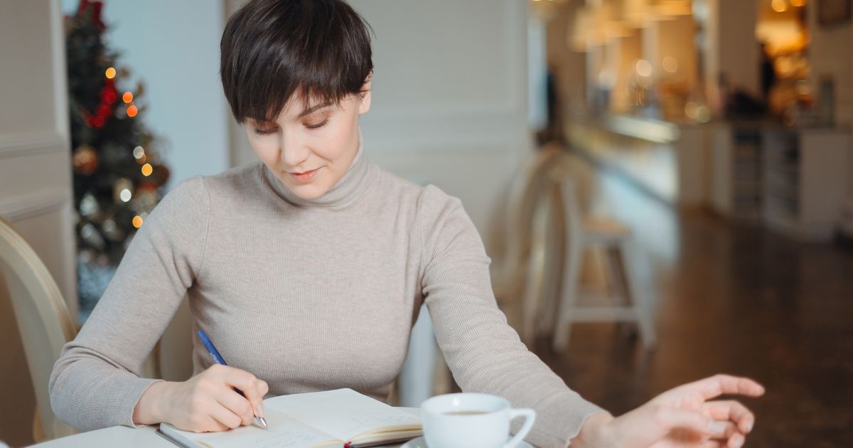 woman planning writing in journal