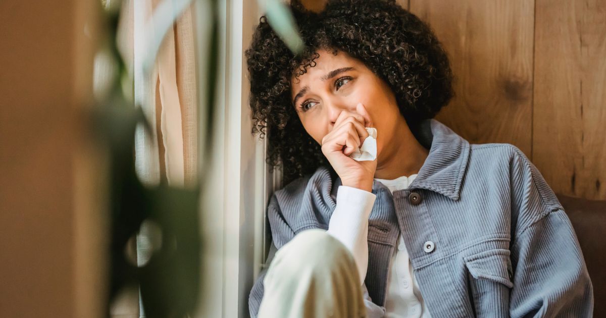sad woman looking out window with no emotional resilience