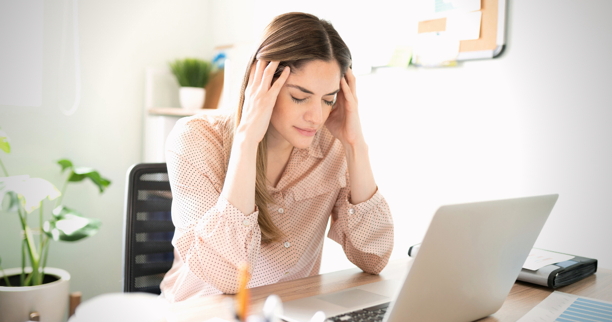 overwhelmed woman stressed over laptop