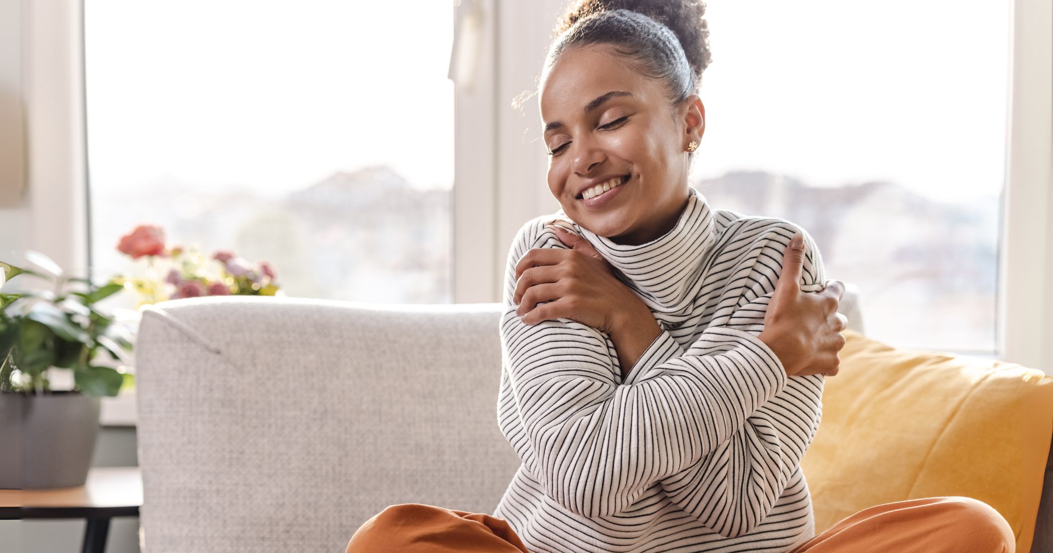 woman hugging herself expressing self-love